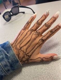 a person's hand with tattoos on it