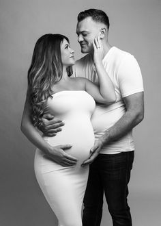 black and white photo of a pregnant couple