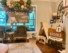 a living room filled with lots of furniture and balloons in the shape of teepees