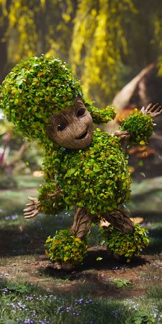 a cartoon character made out of leaves in the grass with trees around him and bushes on his head