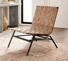 a woven chair sitting on top of a wooden floor