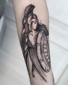 a man's arm with a black and white tattoo on it