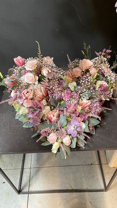 a bunch of flowers sitting on top of a table