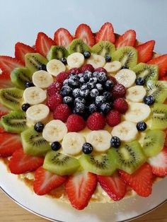 a cake with fruit arranged in the shape of a flower