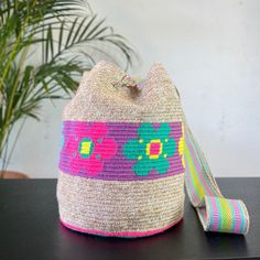 a cat shaped bag sitting on top of a table next to a potted plant