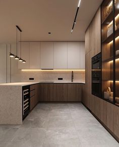 an empty kitchen with lots of counter space and lights on the wall above it,