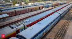 several trains are parked on the tracks in an empty train yard with no people around them