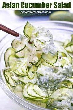 cucumber salad in a glass bowl with a wooden spoon on the side, ready to be eaten