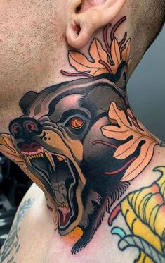 a man with a tattoo on his neck has a bear and flowers on it's side