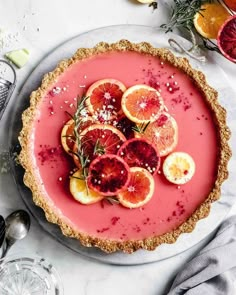 a tart with blood oranges and rosemary garnish