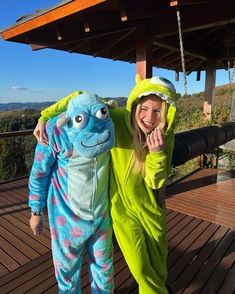 two people dressed in costumes posing for a photo