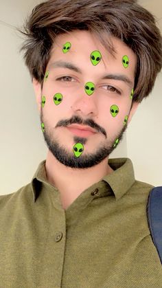 a man with green alien faces on his face