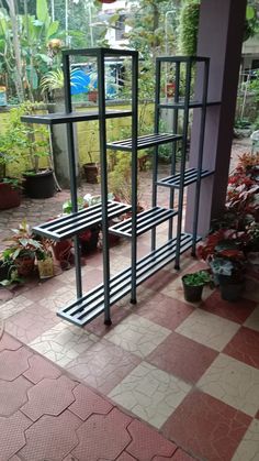 an outdoor area with potted plants and shelves