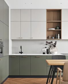 an image of a kitchen setting with white cabinets and wood flooring in the background