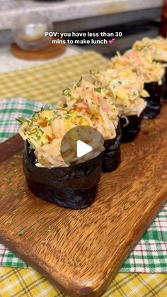 an image of sushi rolls on a wooden board