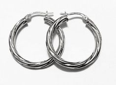 Fancy swirly hoop earrings:metal        : solid 14k yellow gold/solid white goldthick          = 3 mmweight       = 2 grdiameter   = 1"inch (25mm)closure     : snap downmade        : in Italy