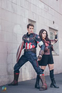 two people dressed as captain america standing next to each other