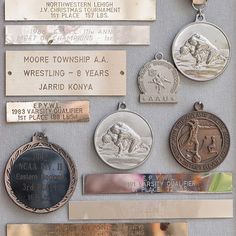 several medals and plaques are displayed on a wall