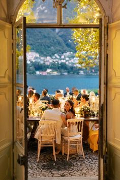 a group of people sitting around a dinner table