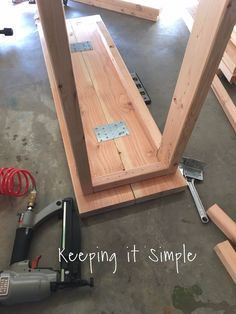 the tools are laying on the floor next to the wooden planks that have been built