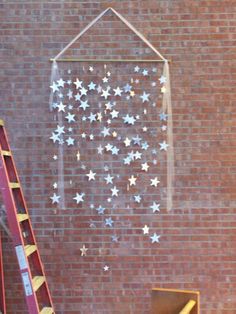 there is a ladder next to a wall with stars on it