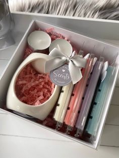 an open box containing candles, spoons and other items