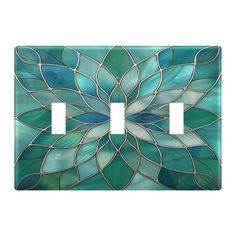 a decorative light switch cover with blue and green leaves