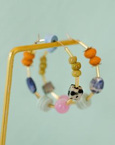 Auden Beaded Hoops Set of bright and colorful beaded hoop earrings DETAILS: 40mm hoops Gold filled hoops Earring post are lead and nickel free. PROCESSING TIME: Our items are made to order. Processing times may vary due to holidays or demand. The processing time for this item is 1-3 weeks before it ships. In order to ship each order on time, we are not able to bypass the processing times on any of our items. If you are under time restraints or live in an area where package theft is common, pleas Hoop Earring Packaging, Trending Earrings 2023, Bead Earrings Ideas, 90s Jewelry Trends, Beaded Hoop Earring, Earring Packaging, Bright Earrings, Unique Hoop Earrings, Address Change