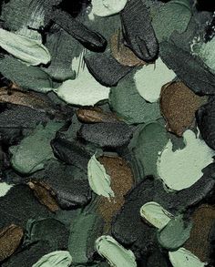 a pile of green and brown rocks next to each other