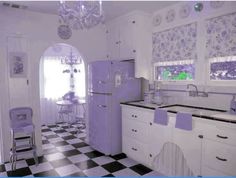 a kitchen with checkered flooring and purple accents on the walls, windows, and cabinets