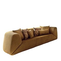 a brown couch with many pillows on it's back and sides, in front of a white background