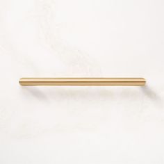 a gold colored handle on a white wall