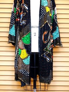 "This is a RARE and FABULOUS vintage piece embellished with bright and colorful sequins and glass beads on black silk and fully lined. There is 1 hook & eye closure at the top. It's in perfect condition! Bust - 56\" + (measured with the front brought together) Upper Arm Circumference - 29\" Top to Bottom Length - 40\" All of my items come from a smoke-free and pet-free home. If you have any questions, please don't hesitate to ask!" Traditional Embellished Evening Outerwear, Fitted Multicolor Outerwear For Festivals, Traditional Black Party Outerwear, Multicolor Embellished Outerwear For Winter, Festive Sequined Outerwear For Festivals, Traditional Embellished Outerwear For Parties, Bohemian Party Outerwear With Sequins, Bohemian Sequined Festive Outerwear, Bohemian Embellished Party Outerwear