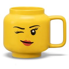 a yellow mug with a face drawn on it