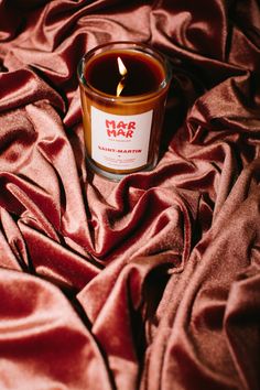 a candle that is sitting on a red cloth with the words har hak