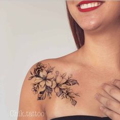 a woman's chest with flowers on it and her hand in the other arm