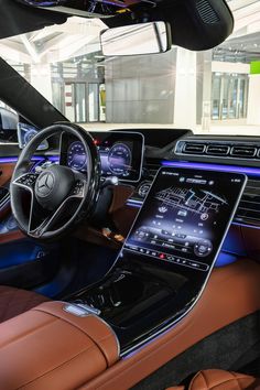 the interior of a mercedes s - class sedan with its touchscreen and steering wheel