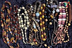 This set of 10 vintage African bead necklaces is a vibrant collection of handmade tribal jewelry. Each necklace features unique beads that vary in length, size, and color, showcasing the rich diversity of African craftsmanship. These necklaces are in various stages of condition and wear, adding to their authentic vintage charm. Perfect for collectors or those looking to add a touch of cultural flair to their wardrobe. Unique Wooden Beads Necklace For Festivals, Unique Wooden Beaded Necklaces For Festivals, Unique Beaded Necklaces With Wooden Beads For Festivals, Vintage Hand-strung Beaded Necklaces For Festivals, Vintage Hand-strung Festival Necklaces, Vintage Hand-strung Necklaces For Festivals, Vintage Hand-strung Beaded Necklace For Festivals, Vintage Hand-strung Necklace For Festival, Handmade Brown Beaded Necklaces For Festivals