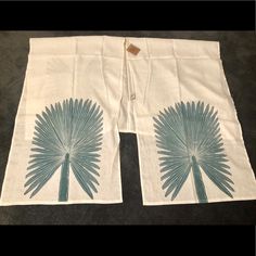 two tea towels with blue flowers on them