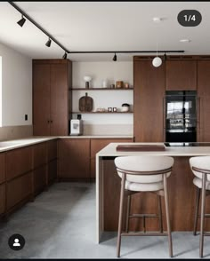 two stools sit at the center of a kitchen island