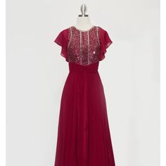 The Attractive Dress Decorated With Sparkling Sequins Has A Light Skirt, A Functional Zipper At The Back That Provides A Secure Fixation Of The Dress. The Back Is Decorated With A Fisheye Keyhole The Sleeveless Dress Has A Tulle Train On The Shoulders. Length: Long Colour: Burgundy Neckline: Jewel Silhouette: A-Line Sleeve: Sleeveless Back: Zipper, Fisheye Keyhole Embellishments: Sequins Occasion: Romantic Date/Evening/Dinner, Wedding/Bridesmaid, Graduation, Fashion Show, Visiting Theater/Museum Sleeveless Red Chiffon Evening Dress, Red Sleeveless Chiffon Evening Dress, Burgundy Sleeveless Maxi Dress For Prom, Festive Sequins Bridesmaid Dress, Burgundy Sleeveless Evening Dress, Festive Bridesmaid Dresses With Sequins, Sleeveless Burgundy Holiday Dress, Burgundy Sleeveless Holiday Dress, Festive Burgundy Dress