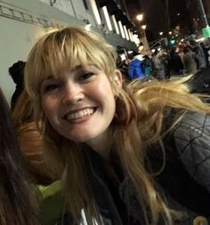 two young women are smiling for the camera