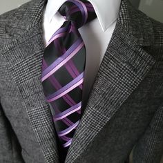 Elevate your formal wear with our Black Purple Plaid Silk Tie. Made with high quality silk, this tie is the perfect accessory for any wedding or special occasion. The unique plaid pattern and bold black and purple colors make it a standout piece that will add sophistication to any outfit. 100% Silk Handmade Package Includes: Tie Length: 59" Width: 3.34" Warm iron if needed All Black Suit With Purple Tie, Purple Suit And Tie Accessories For Black Tie Events, Elegant Plaid Suit And Tie Accessories For Business, Fitted Purple Suit And Tie Accessories For Office, Black Suits With Purple Ties, Elegant Purple Tie For Office, Elegant Purple Office Ties, Mens Pocket Squares Purpke Velvet Tie, Luxury Classic Purple Ties