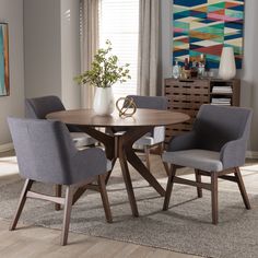 a dining room table with four chairs around it