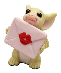 a small toy pig holding a pink envelope