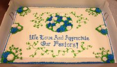 a sheet cake with blue and green frosting in a white box that says, we love and appreciate our pastor