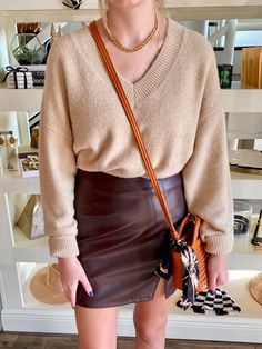 Neutral color sweater paired with a brown faux leather skirt Neutral Sweater, Leather Skirt Outfit, Neutral Sweaters, Faux Leather Mini Skirt, Leather Mini Skirt, Skirt Outfit, Faux Leather Skirt