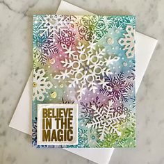 a card with snowflakes on it and believe in the magic stamping paper