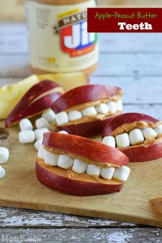 apples with marshmallows and peanut butter are arranged in the shape of an apple smile