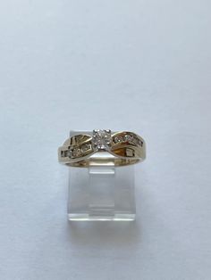 This is an absolutely beautiful vintage 14 karat yellow gold diamond wedding or engagement ring. The ring has a Centerstone that measures 1/4 carat. It is a SI, G-H  grade On either side of the Center stone are 8 smaller diamonds each .03 caret Total Diamond weight of ring is over 1/2 caret.  The ring is a size 5 1/2. It is hallmarked 14 K. It weighs 3.8 g. It is 5.6 mm wide. The stone sits 6.3 mm off the finger  This ring is an excellent preowned vintage condition with normal wear for the age. All stones are secure and the band shank shows little to no wear Heirloom Diamond Ring Stamped 14k, Classic Diamond White Ring Stamped 14k, Heirloom 14k Gold Diamond Ring For Anniversary, Princess Cut Diamond Ring With Accents In 14k Gold, 14k Gold Princess Cut Diamond Ring With Accents, Yellow Gold Princess Cut Diamond Ring With Accents, Classic Round Cut Diamond Ring Stamped 14k, 14k Stamped Diamond Wedding Ring, Promise Diamond Ring Stamped 14k Round Cut